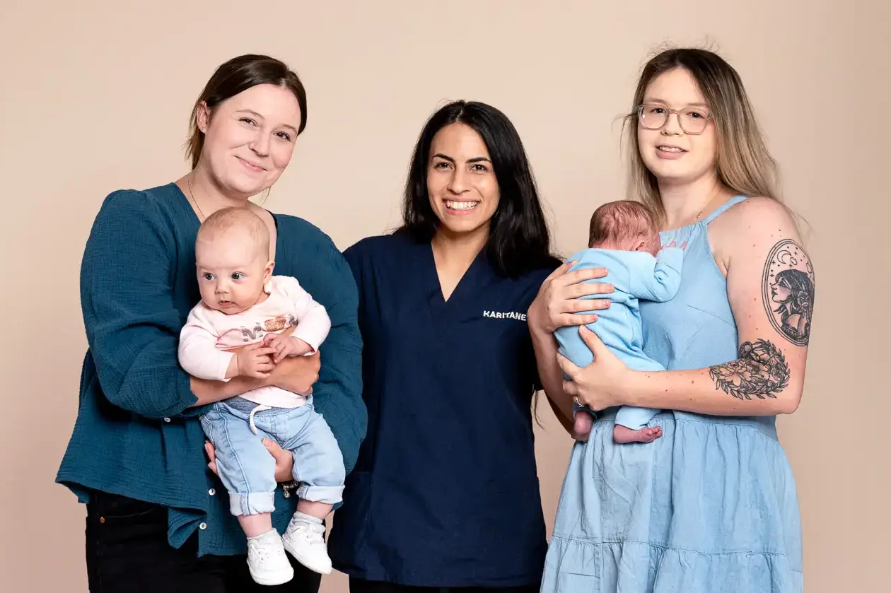 Annual report photography capturing three smiling women in casual attire, each holding an infant, against a soft beige backdrop