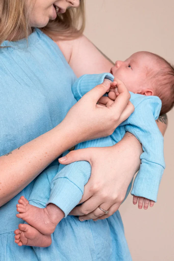 Close-up portrait of a mother holding her baby for Karitane annual report photography