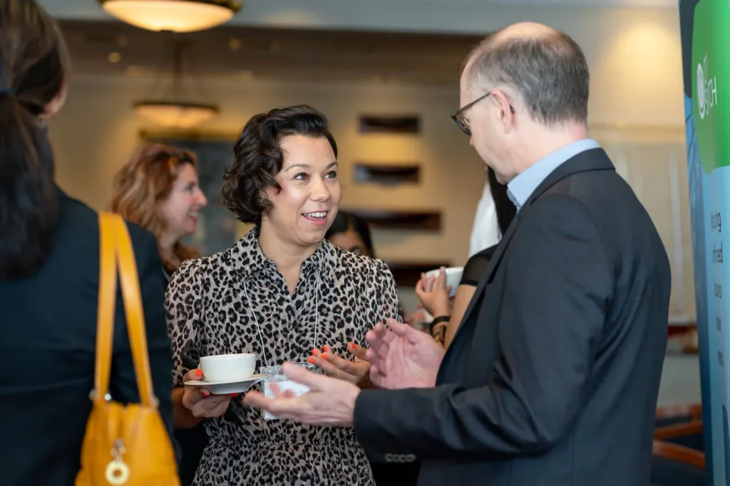 Business professionals exchanging ideas at the net zero breakfast