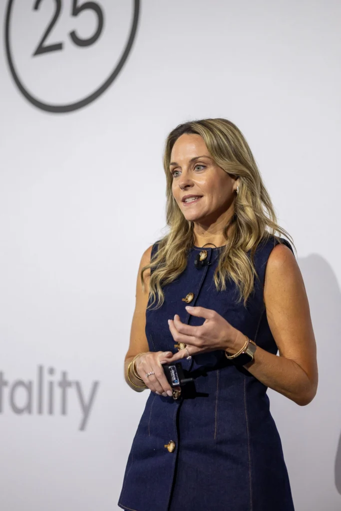 Speaker on stage delivering conference talk