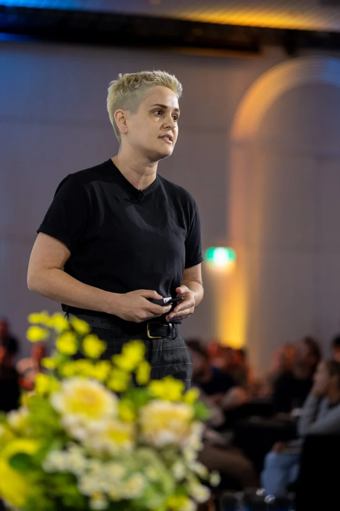 Speaker on stage delivering conference talk
