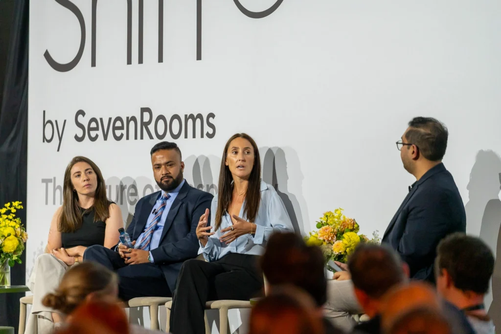 Wide shot of panel discussion at Ivy Ballroom