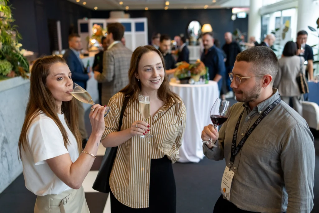 Guests laughing and enjoying afterparty atmosphere