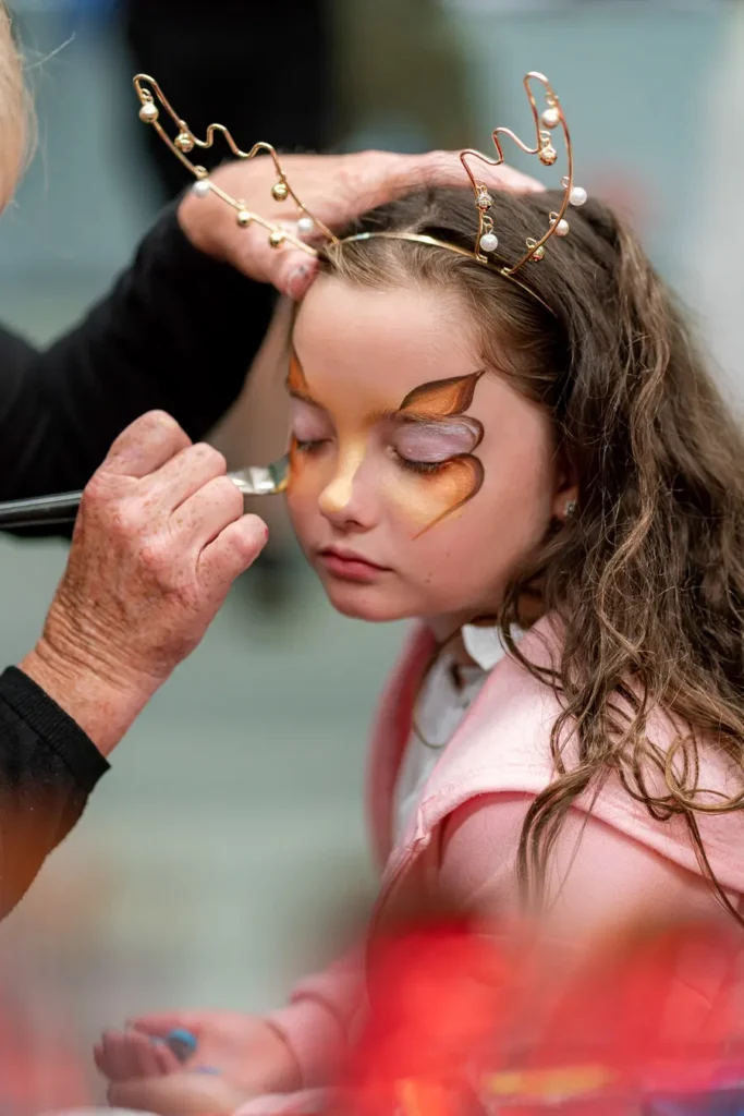 Child having face painting done at a Sydney Christmas party function