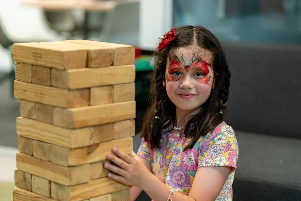 Child playing giant Jenga at a Sydney Christmas party function