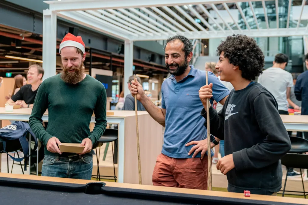 Guests playing pool at an office Christmas party in Sydney