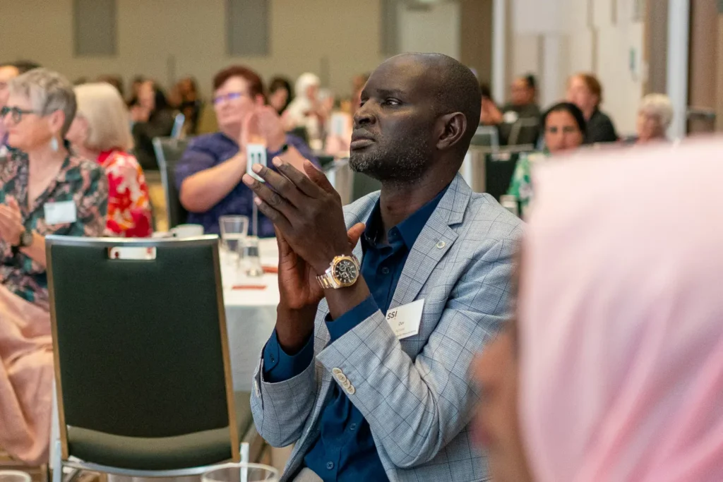 Guest applauding during the Silence to Power conference at PARKROYAL Parramatta