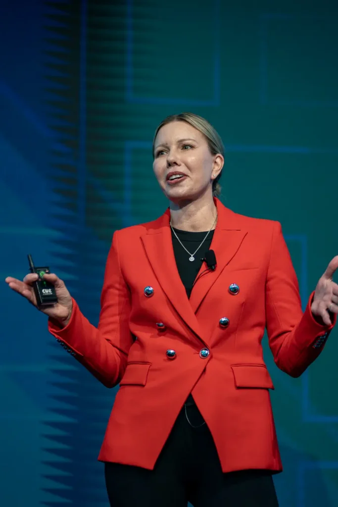 Close-up of a speaker in a red blazer presenting at Guidewire Insurance Forum Sydney 2023