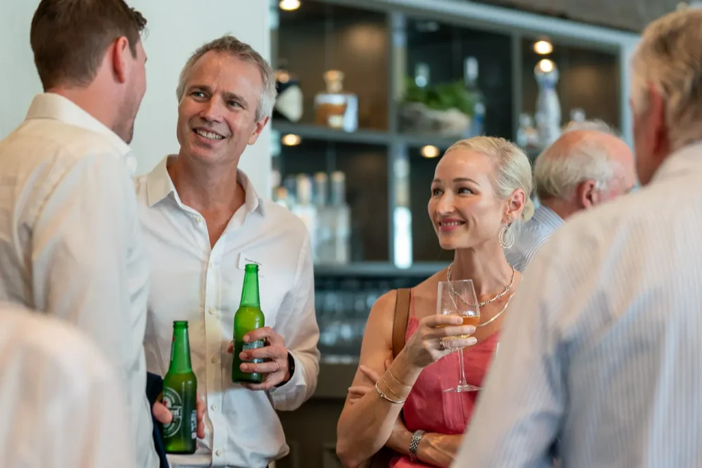 Guests chatting over drinks at the Michael Morgan OAM lunch at Deckhouse Woolwich