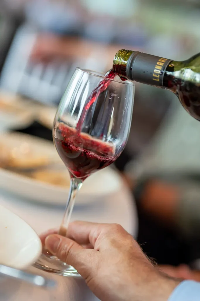 Red wine being poured during the Michael Morgan OAM lunch at Deckhouse Woolwich