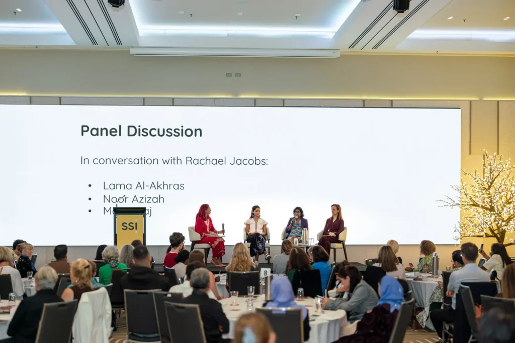 Wide view of the panel discussion on stage at the Silence to Power conference