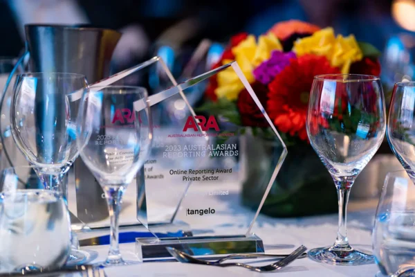 Australasian Reporting Awards trophies displayed on a black-tie dinner table at the 2023 ARA gala