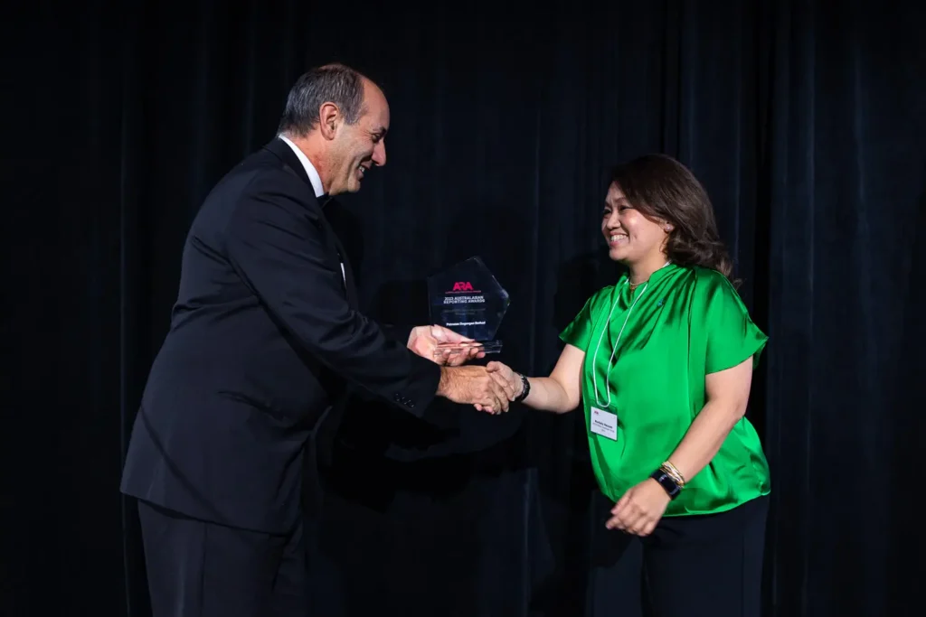 Trophy presentation handshake during the Australasian Reporting Awards ceremony