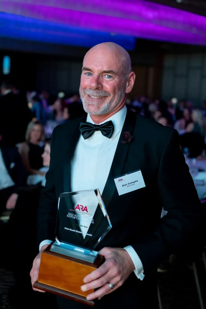 ARA Chair Alan Colegate posing with award trophy at the Australasian Reporting Awards