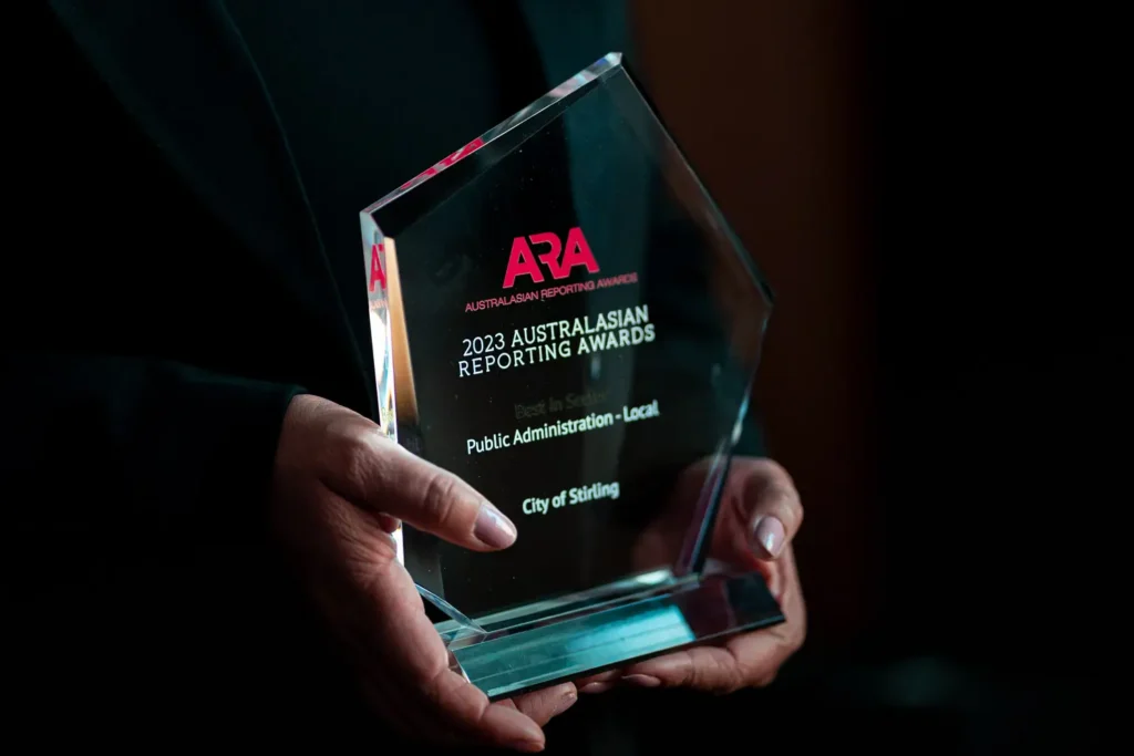Close-up of the 2023 Australasian Reporting Awards Public Administration Local trophy held during a black-tie dinner awards ceremony