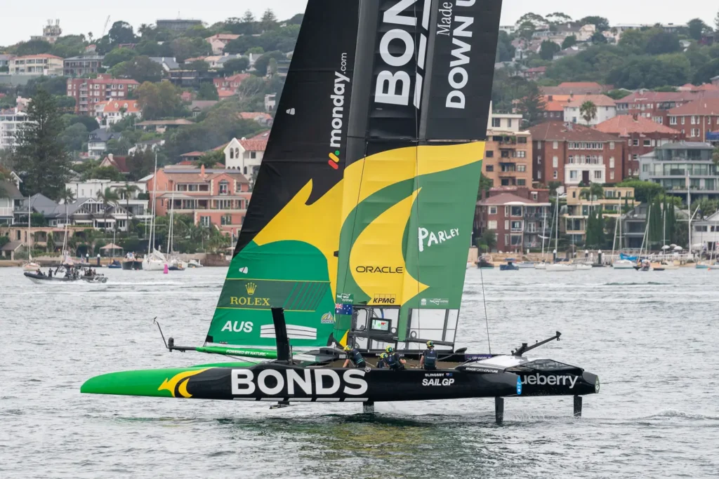 Australia SailGP Team BONDS F50 catamaran foiling on Sydney Harbour with “Powered by Nature” branding visible