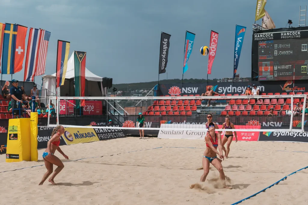 Australian women’s beach volleyball team preparing to receive the ball on Manly Beach