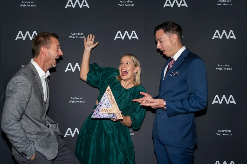 Guests posing with Australian Web Awards winner trophy