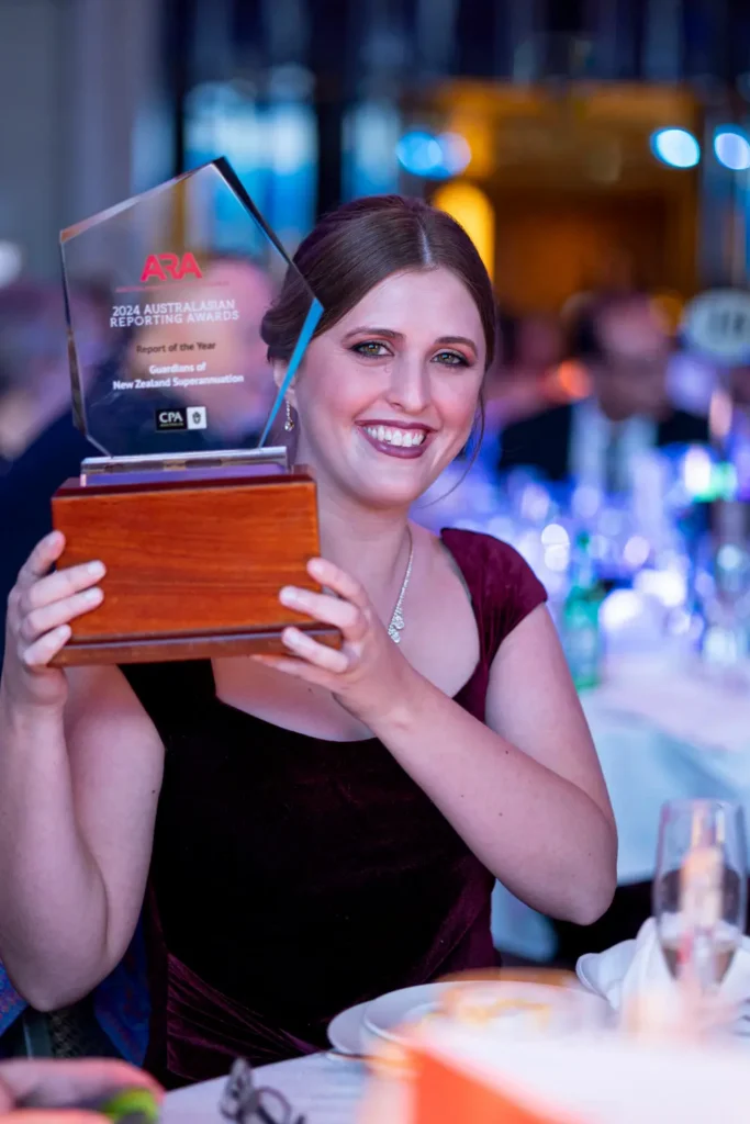 Award winner holding trophy during gala dinner awards event