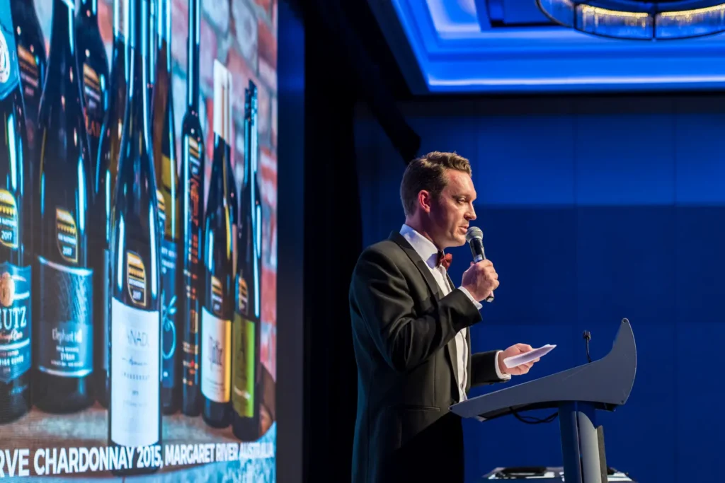 Speaker presenting on stage during Sydney awards night event