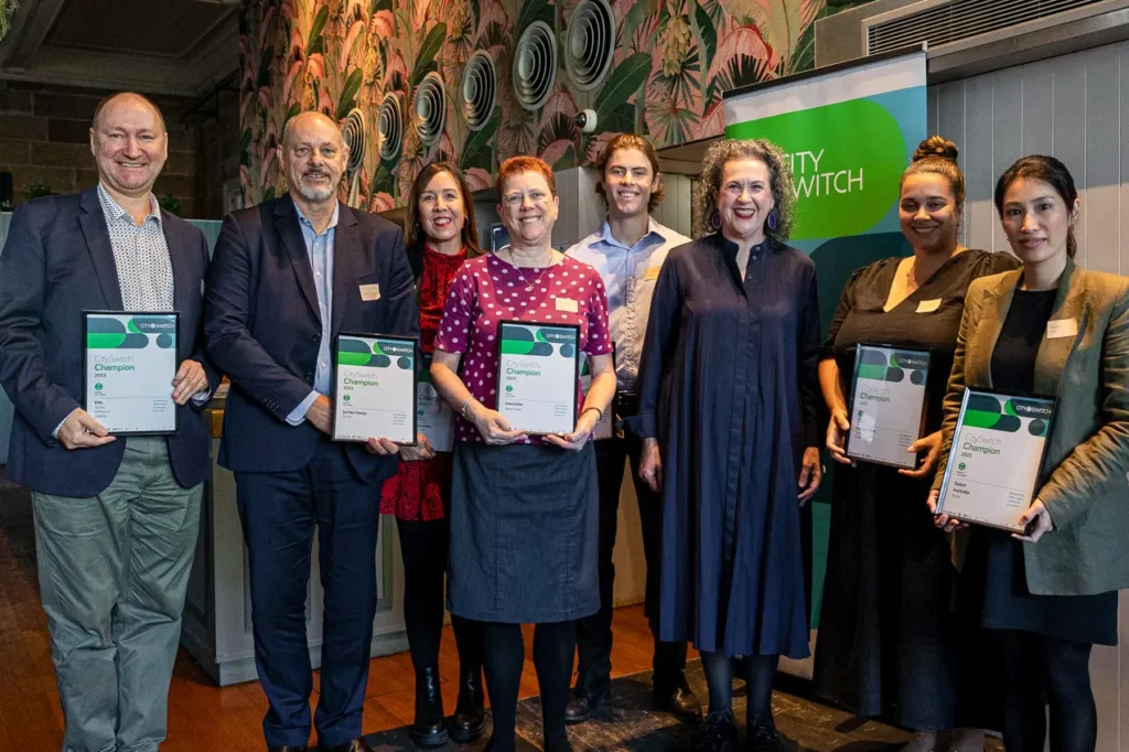 Group portrait of sustainability award winners at corporate event