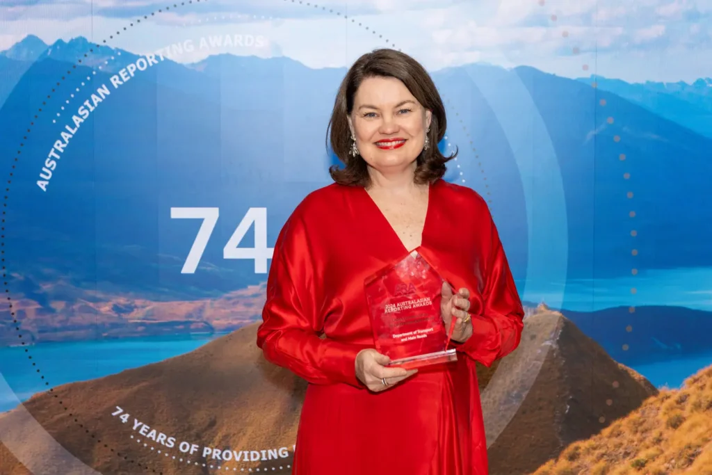 Female awards winner holding trophy at gala awards night