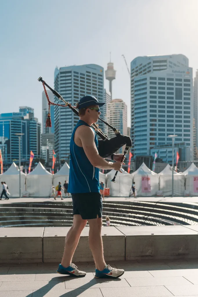 Musician playing bagpipes during Dragon Boat Racing event at Darling Harbour Sydney