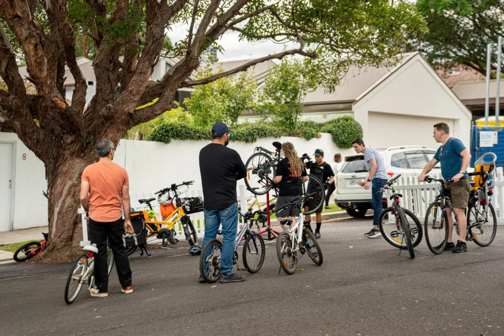 Residents receiving bicycle repairs during Street Play community gathering