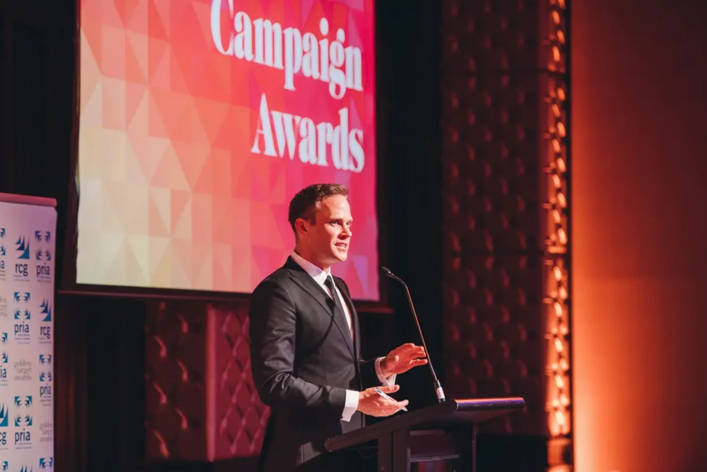 Presenter speaking on stage during campaign awards event