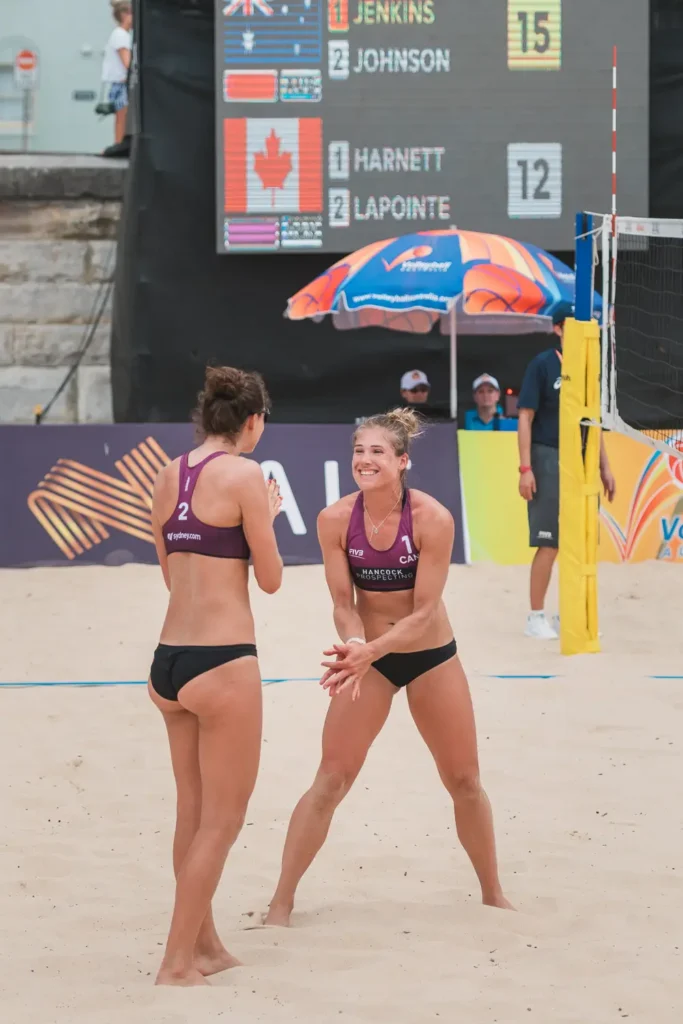 Canadian beach volleyball teammates celebrating a point at Manly Beach