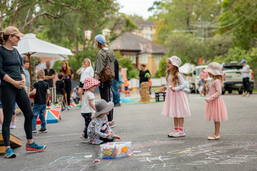 Children playing and drawing with chalk during family event in Wollstonecraft
