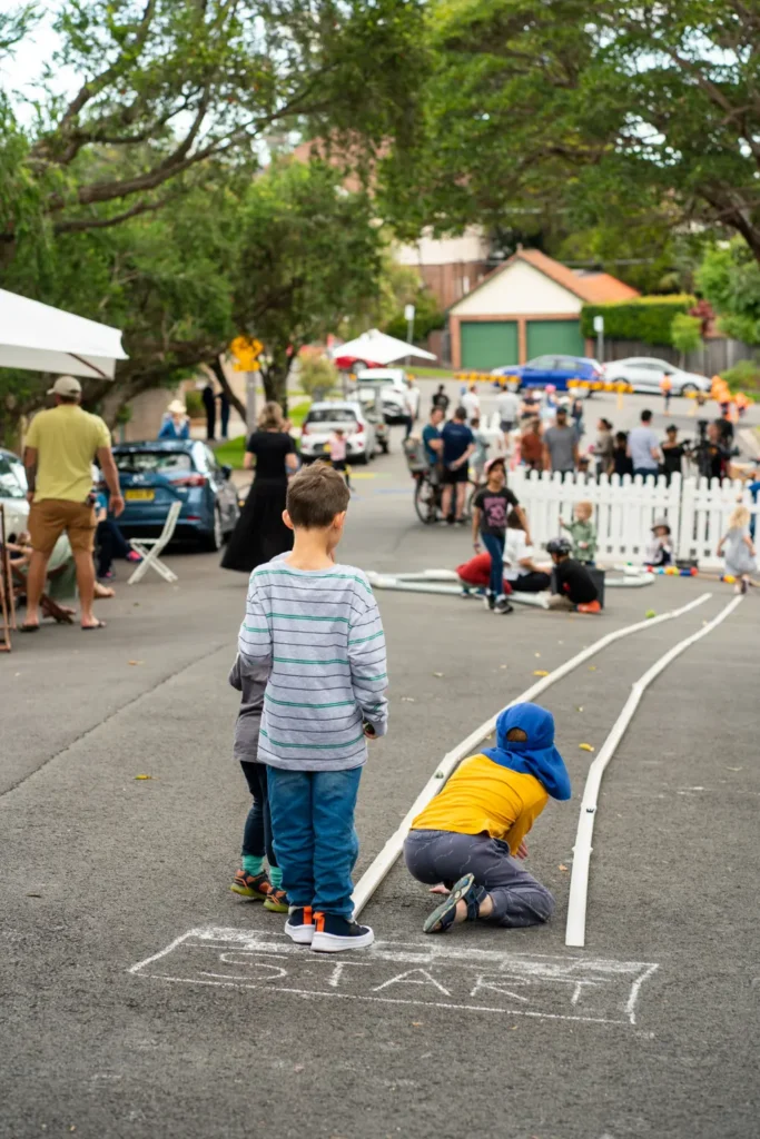 Children gathered at the start of a homemade street racing track during a neighbourhood open street event