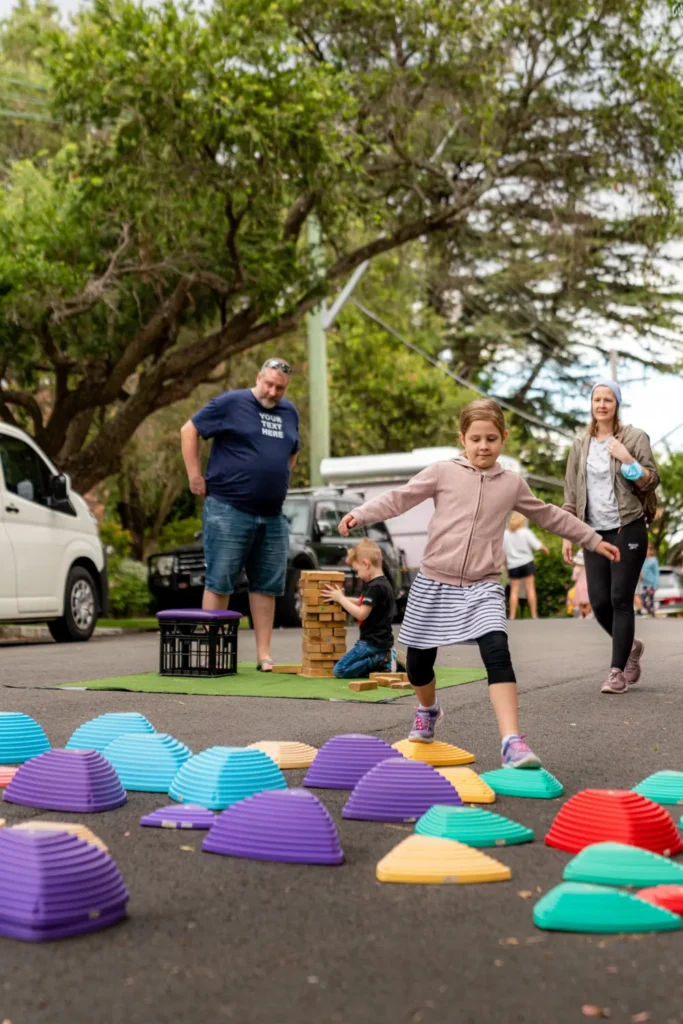 Child playing balancing games during North Sydney community street event