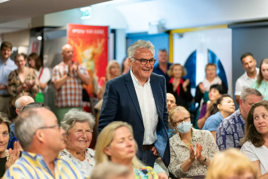 Audience applauding during community awards presentation ceremony