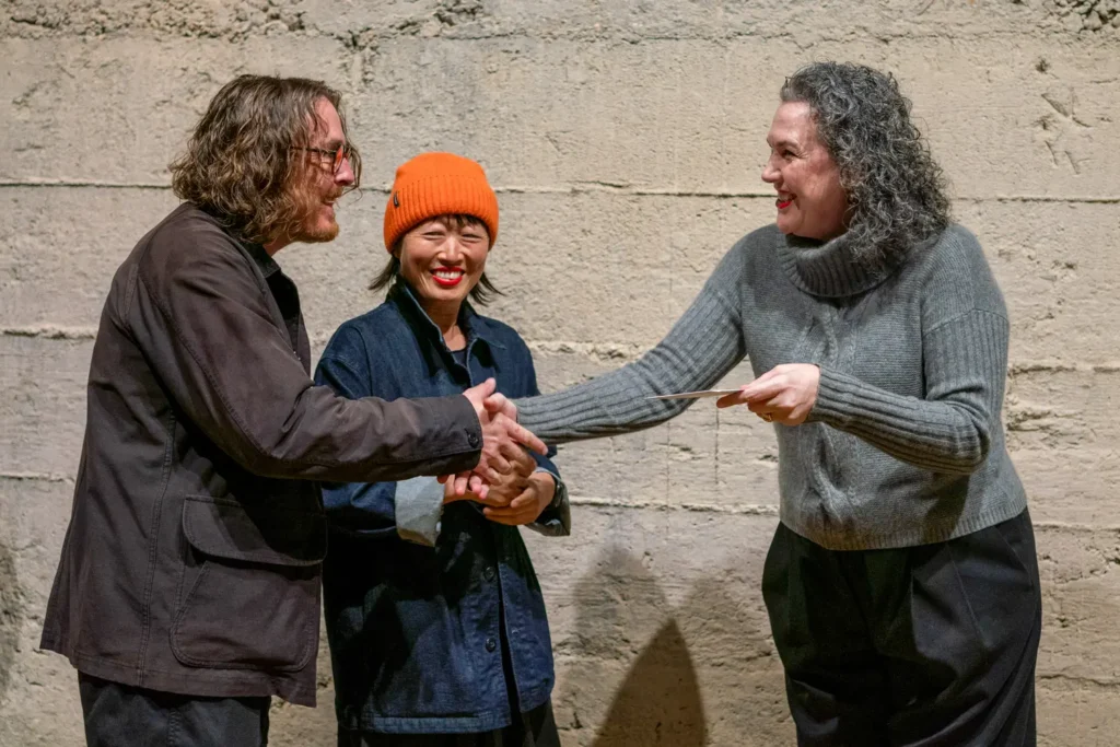 Community awards presentation and handshake photographed in Sydney