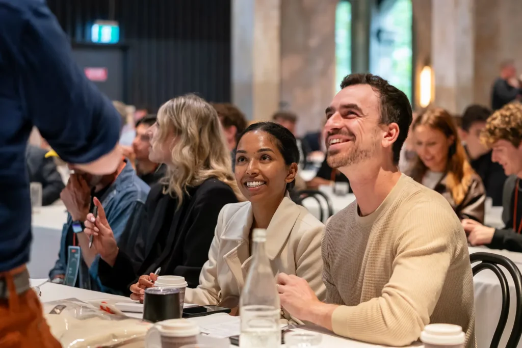 Conference attendees engaged in keynote session at Alpha Dining Sydney