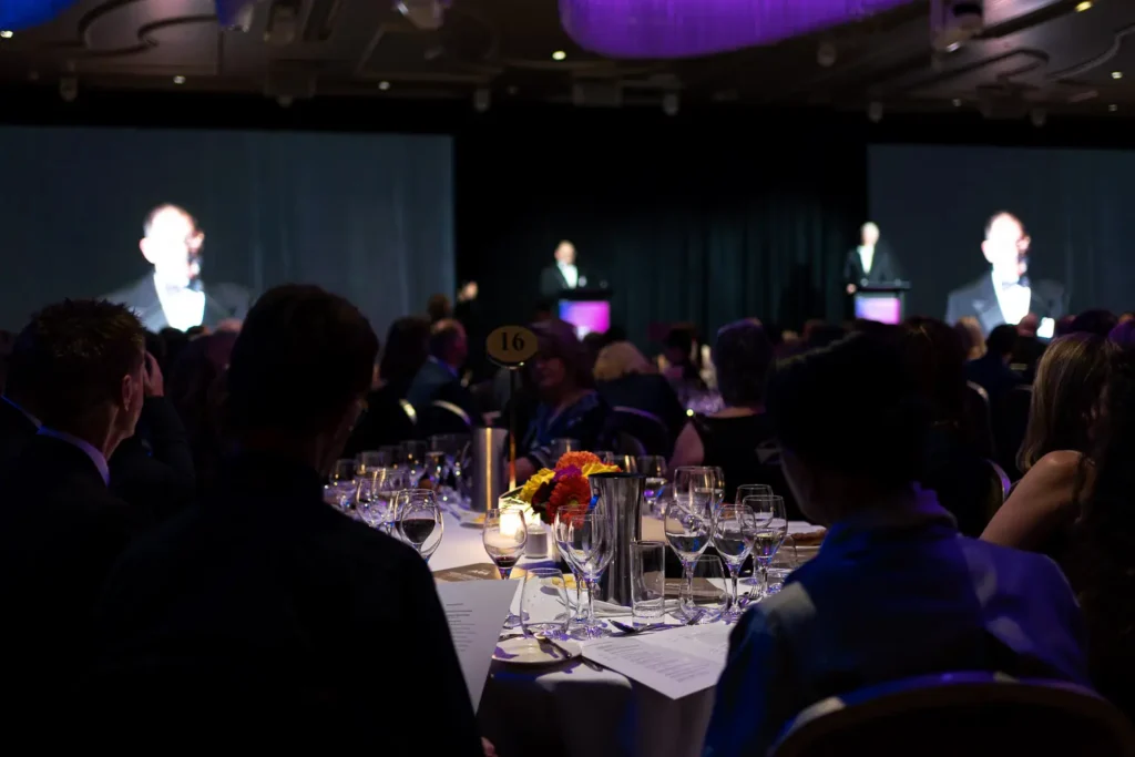 Audience watching keynote presentation during corporate gala dinner at Shangri-La Sydney