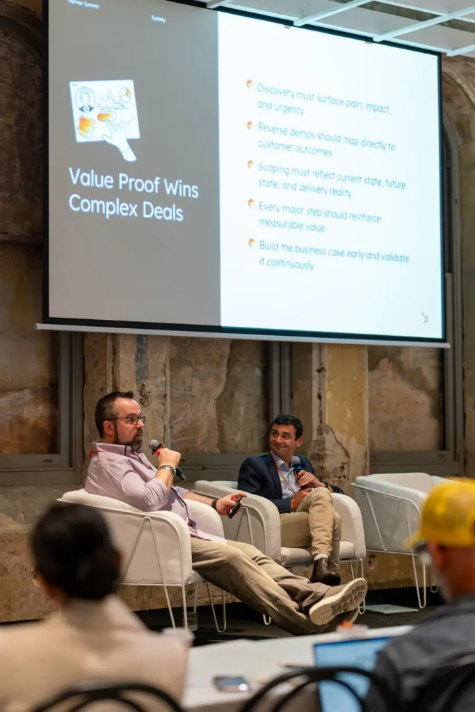 Daniel Stevens and the Fileroom Director speaking during a corporate conference panel discussion in front of a presentation screen
