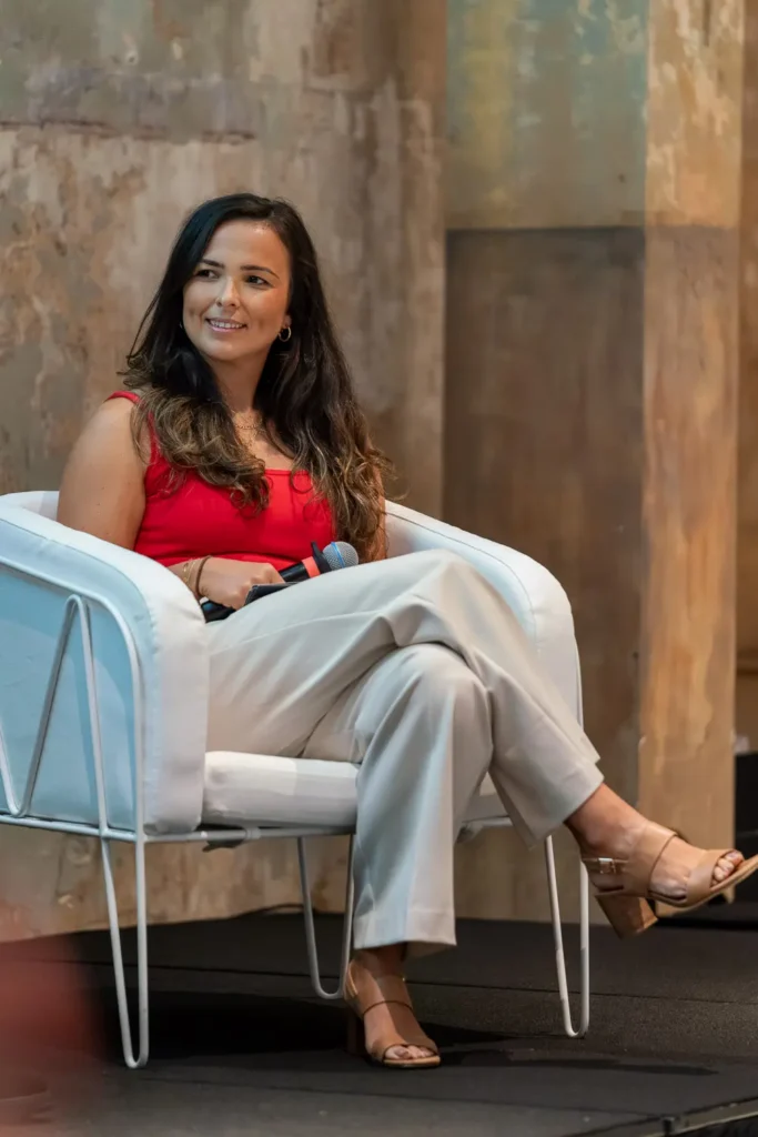 Danielle Gormley speaking during a corporate panel discussion at a partner summit conference