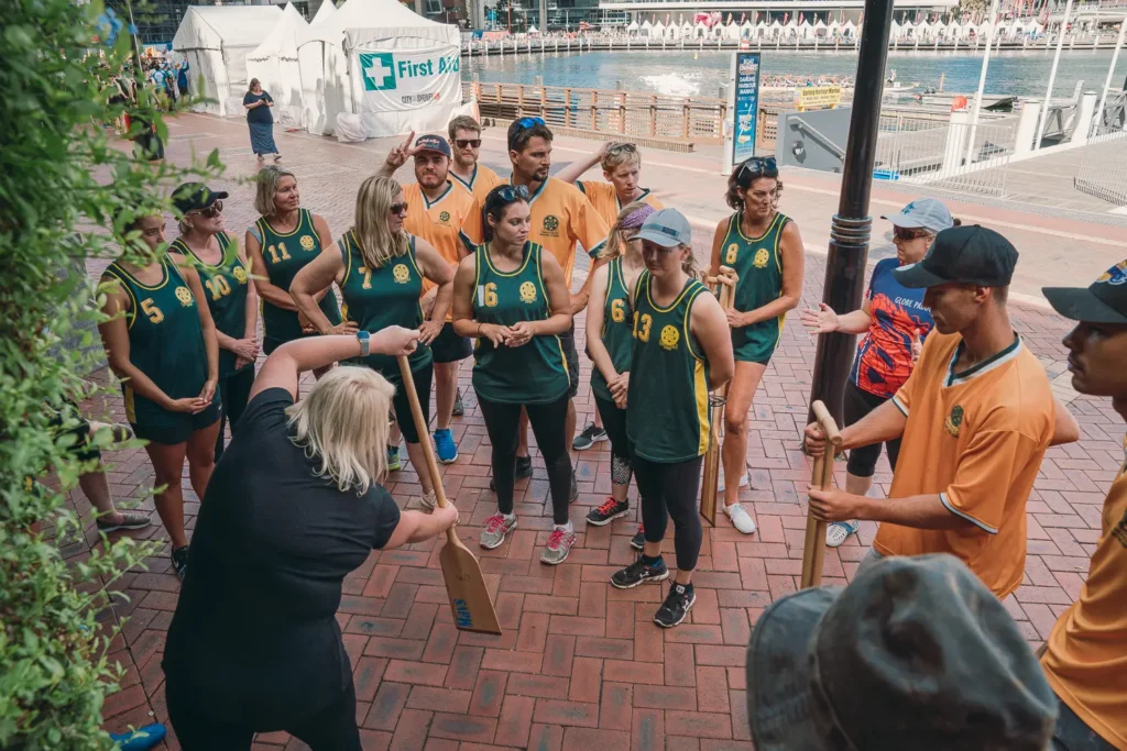 Dragon boat team receiving paddling instructions beside Darling Harbour marina