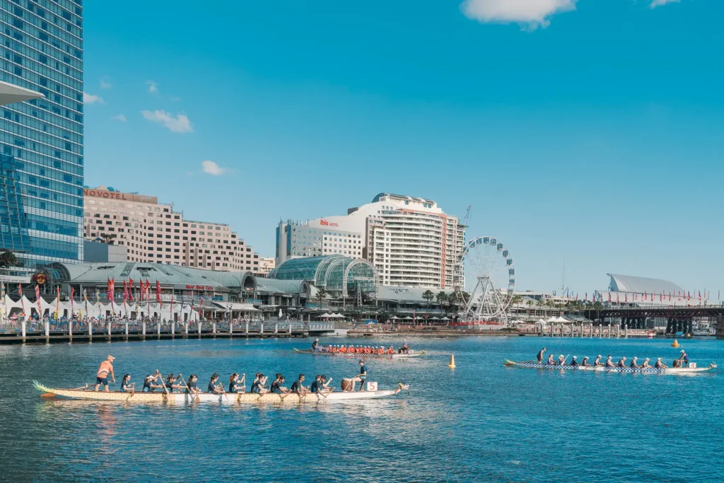 Dragon boat teams racing across Darling Harbour during Sydney Lunar New Year festival