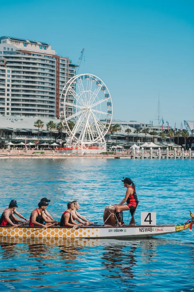 Front drummer guiding a dragon boat crew during race competition