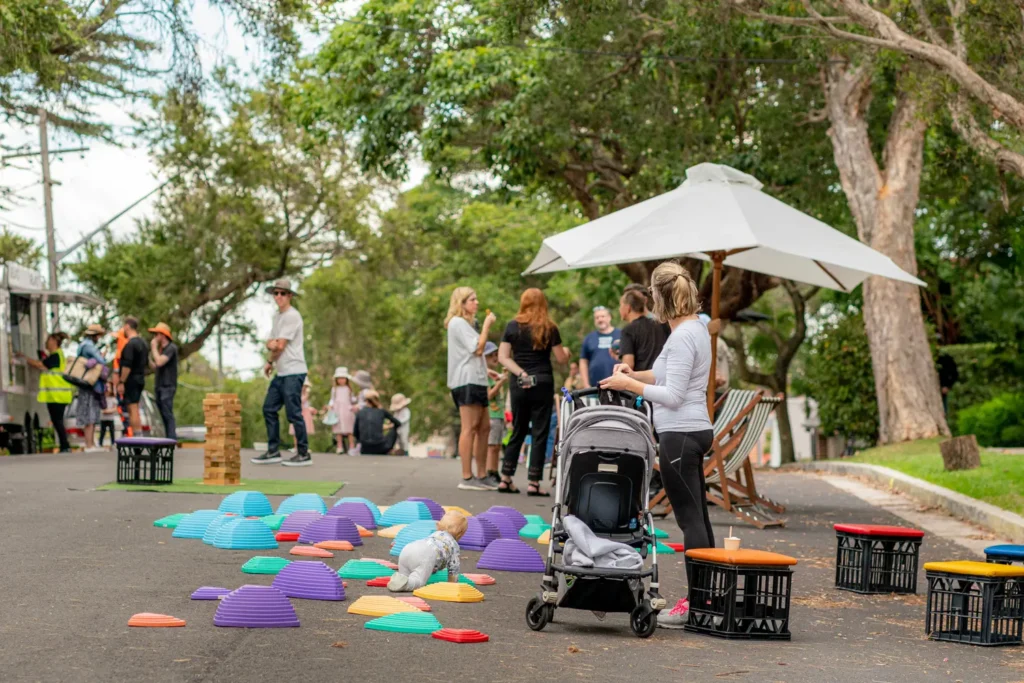 Families gathering outdoors during community Street Play event in Sydney