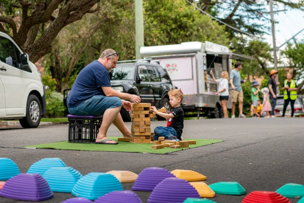 Parent and child playing giant garden games at Street Play in Wollstonecraft