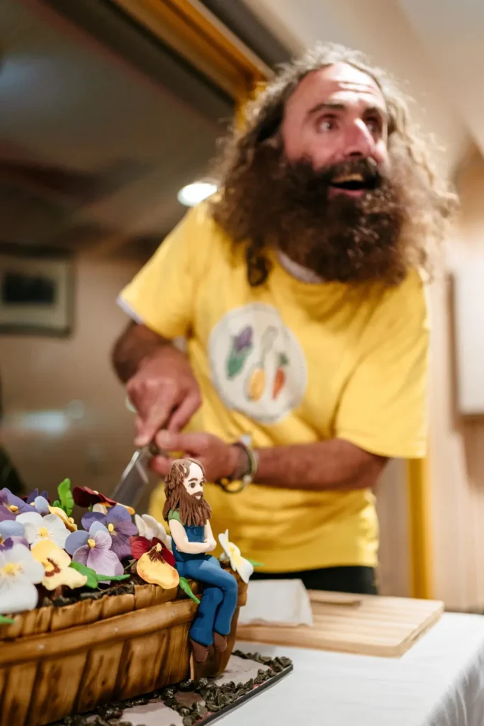 Garden-themed celebration cake being cut at community awards event