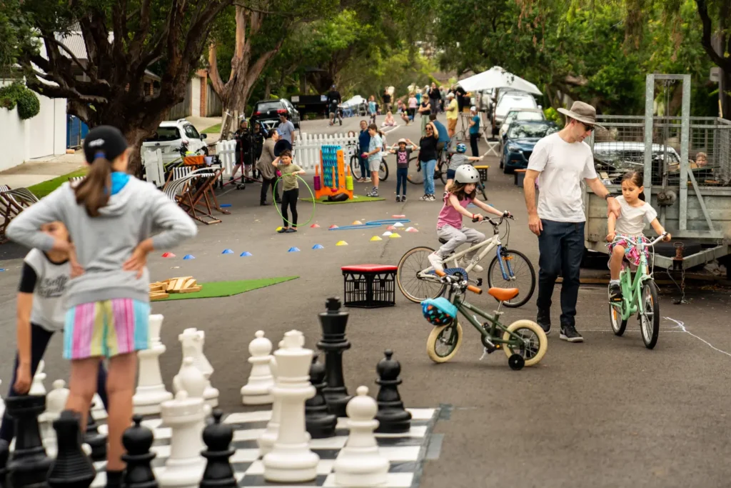 Children playing giant chess at family-friendly community event in Sydney