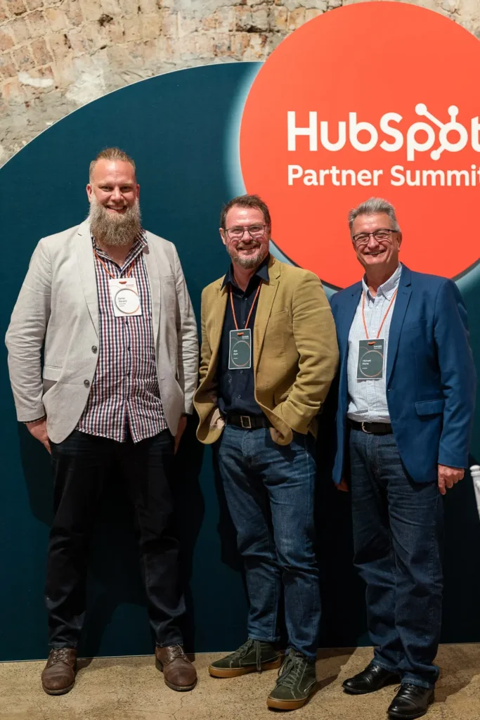 HubSpot partners posing at conference backdrop inside Alpha Dining Sydney