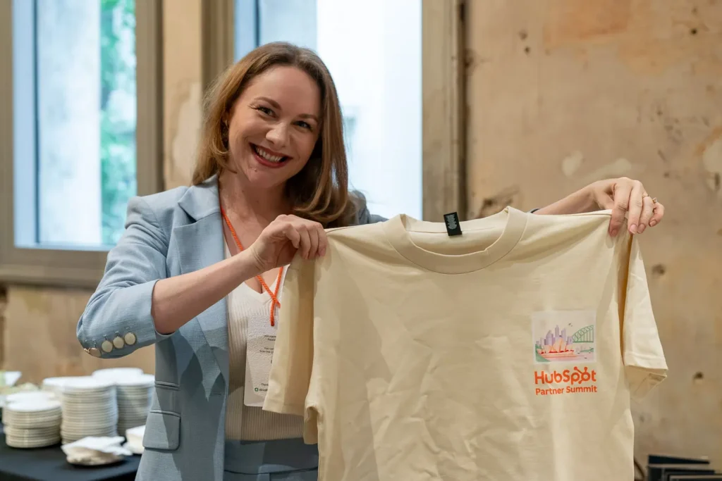 Attendee holding HubSpot Partner Summit merchandise at Alpha Dining Sydney