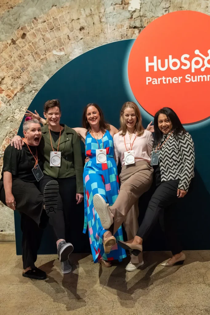 HubSpot partners posing at branded event backdrop inside Alpha Dining Sydney