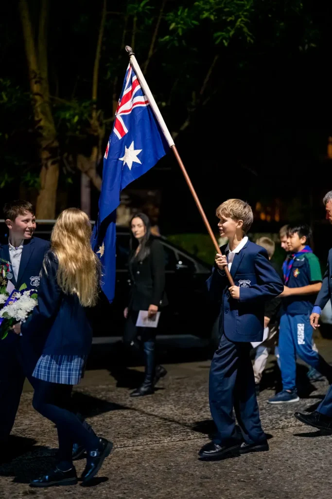 School children carrying the Australian flag during the Hunters Hill ANZAC march